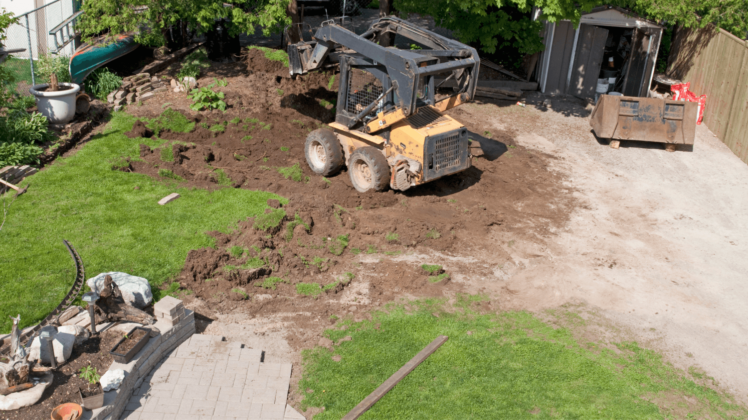 Garden being dug up with small digger