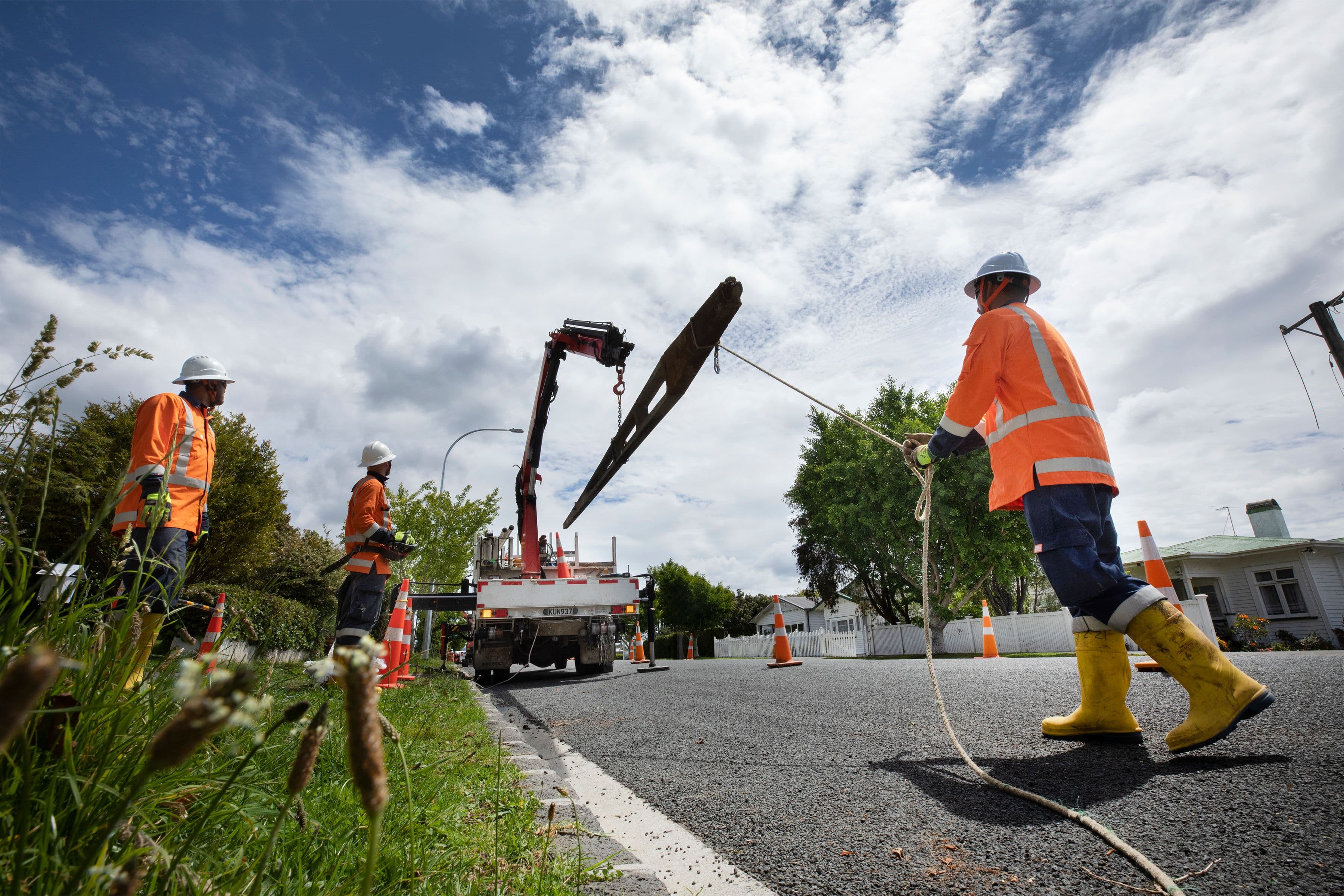 crew loading a pole on a truck during undergrounding of power lines